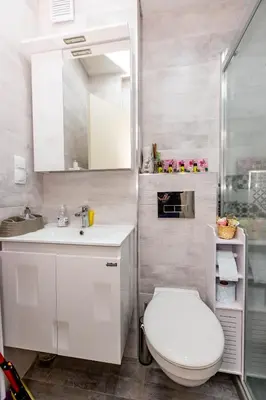 a white bathroom with a toilet and a sink at City Home Sandanski in Sandanski