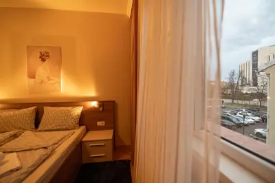 a small bedroom with a bed and a window at NDK Garden at Vitosha Blvd Absolutely Top Center with Free Parking in Sofia