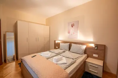 a bedroom with a bed with a picture on the wall at NDK Garden at Vitosha Blvd Absolutely Top Center with Free Parking in Sofia