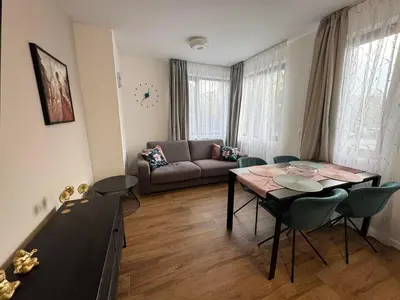 a living room with a table and a couch at Harmony Apartment by 7th Sence in Sofia