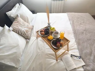 a tray of food and drinks on a bed at Urban Atelier 300m from Gondola, Free Bottle of Wine, free Parking in Bansko