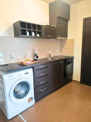 a kitchen with a washing machine and a sink at Urban Atelier 300m from Gondola, Free Bottle of Wine, free Parking in Bansko