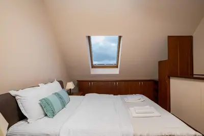 a bedroom with a large bed with a window at Flower garden in Lozenetz by 7th Sence in Sofia