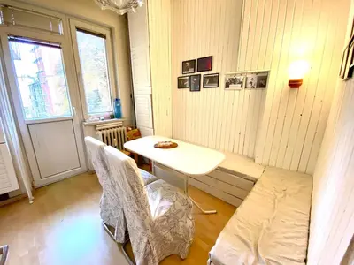 a small room with a table and chairs and a window at Comedy Theatre apartments in Sofia