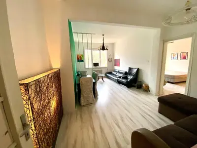 a living room with a couch and a table at Comedy Theatre apartments in Sofia