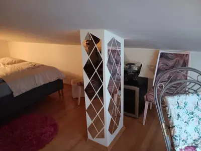 a dresser in a room with a bed and a bed sqor at Аppartment Dreams in Pamporovo