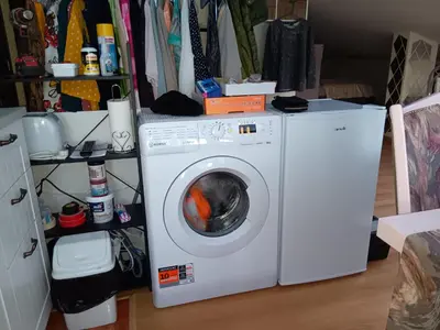 a white washing machine sitting in a room at Аppartment Dreams in Pamporovo