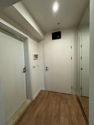 an empty room with white walls and wooden floors at Apartment Alex in Borovets