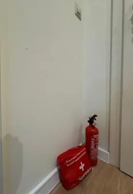 a fire extinguisher and a red bag in a room at Apartment Alex in Borovets