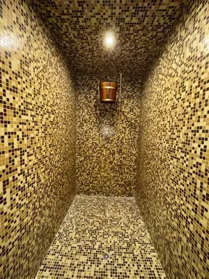 a corner of a tiled room with a light at Apartment Alex in Borovets