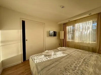 a bedroom with a bed and a large window at Apartment Alex in Borovets