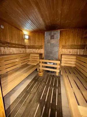 a empty sauna with wooden benches and a wooden ceiling at Apartment Alex in Borovets