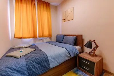 a bedroom with a bed and a lamp and a window at 1 minute to main Street Grafa, NDK, FREE Parking, 3BDR in Sofia