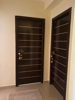 two brown doors with christmas decorations on them at Ava Apartment Pamporovo in Pamporovo