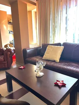 a living room with a couch and a coffee table at Ava Apartment Pamporovo in Pamporovo