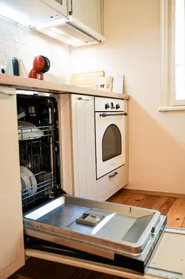 a kitchen with an open dishwasher and a stove at Big Apartment in Center Sofia - 2 BD - Fireplace in Sofia
