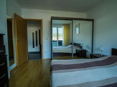 a hotel room with a bed and a mirror at Apartment with an amazing view - near Bansko in Razlog