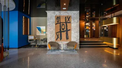 a lobby with a table and chairs in a building at Unique Designer Retreat | Mins to Gondola - Patio! in Bansko