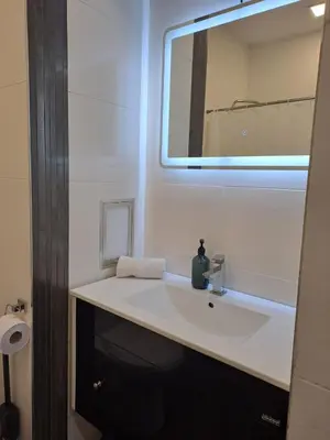 a bathroom with a sink and a mirror at LevskiG Family Flat 10 min from Sofia Airport and city center in Sofia