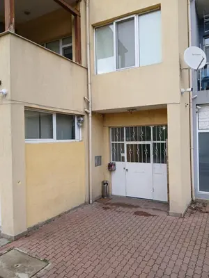 an apartment building with a garage and a door at LevskiG Family Flat 10 min from Sofia Airport and city center in Sofia