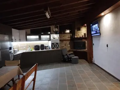 a room with a kitchen and a living room at Странската изба град Калофер in Kalofer