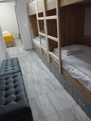 a room with two bunk beds and a stool at Странската изба град Калофер in Kalofer