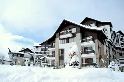 a large building covered in snow in front at Mountain View Studio Borovets Hills A60 in Borovets