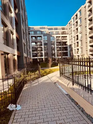 a walkway in front of a building with buildings at Eternity place in Sofia