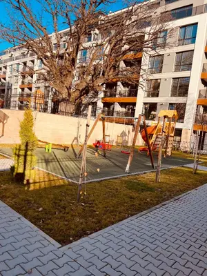 a playground in front of a large building at Eternity place in Sofia