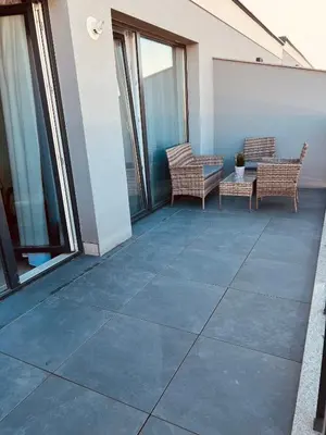 a patio with two chairs and a table on a building at Eternity place in Sofia