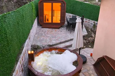 a bath tub filled with snow next to a table at Villa Natalia in Kremen
