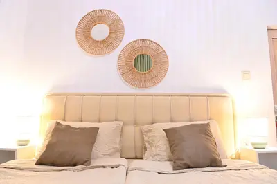 a bedroom with a bed with two mirrors on the wall at Villa Natalia in Kremen