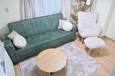 a living room with a green couch and a table at Villa Natalia in Kremen