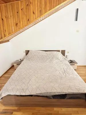 a bed in a room under an attic at Cozy two room maisonette apartment in Samokov