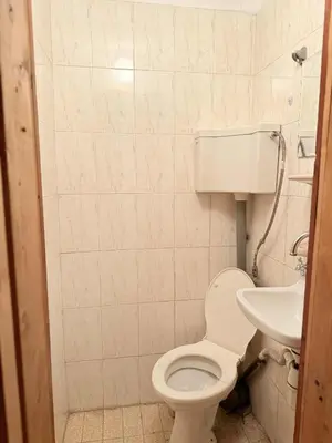 a bathroom with a toilet and a sink at Cozy two room maisonette apartment in Samokov