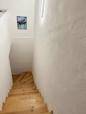 a staircase in a room with a picture on the wall at Cozy two room maisonette apartment in Samokov