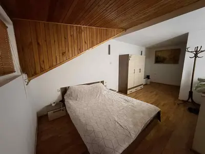 a bedroom with a bed and a wooden ceiling at Cozy two room maisonette apartment in Samokov