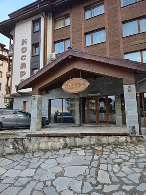 a hotel building with a sign in front of it at Апартамент Kosara 44 in Bansko