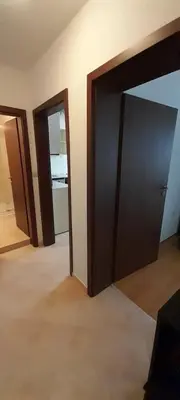 an empty room with a door and a room with a door at Апартамент Kosara 44 in Bansko
