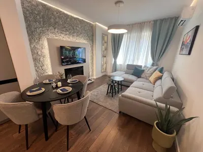 a living room with a couch and a table at Celestial Stylish Central 2BDR w WiFi and Work Space in Sofia