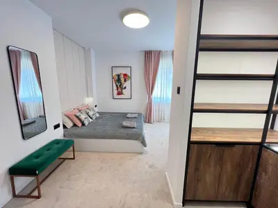 a bedroom with a bunk bed and a green bench at Celestial Stylish Central 2BDR w WiFi and Work Space in Sofia