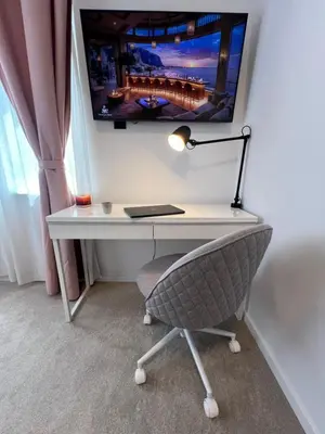 a desk with a monitor and a chair with a lamp at Celestial Stylish Central 2BDR w WiFi and Work Space in Sofia