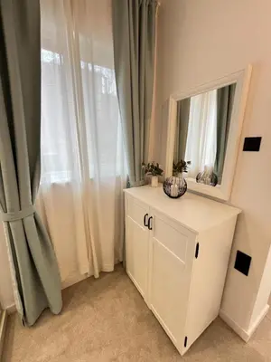 a white dresser with a mirror and a window at Celestial Stylish Central 2BDR w WiFi and Work Space in Sofia