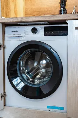 a washing machine sitting inside of a cabinet at Best Central Lux Studio in Bansko