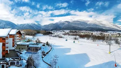 a snow covered ski slope with mountains in the background at Best Central Lux Studio in Bansko