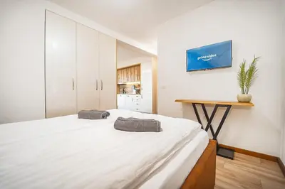 a bedroom with a large bed and a table at Best Central Lux Studio in Bansko