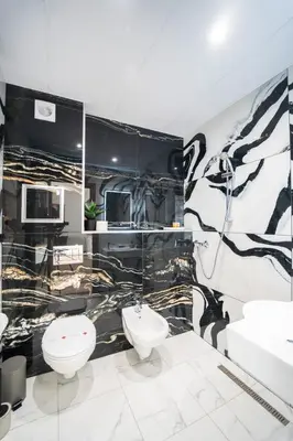 a black and white bathroom with two toilets and a sink at Best Central LUX Studio in Bansko
