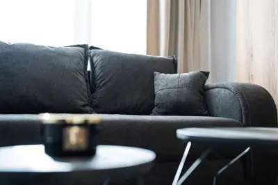 a couch with pillows and a table in a living room at Best Central LUX Studio in Bansko