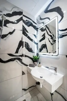 a bathroom with a sink and a mirror at Best Central LUX Studio in Bansko