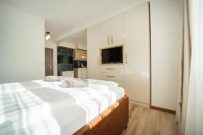 a large white bedroom with a large bed in it at Best Central LUX Studio in Bansko